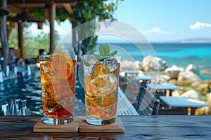 Fresh summer drinks cocktails with berries, fruits, ice and frost on glasses. Vacation open beach bar concept.