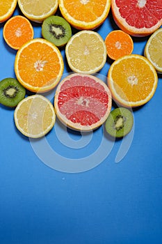 Fresh summer fruits on blue background.