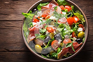 Fresh summer medley Lettuce, olives, tomatoes, parmesan, and prosciutto salad
