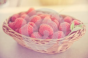 Fresh summer raspberry in a basket. Selective focus.