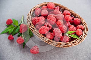 Fresh summer raspberry in a basket. Selective focus.
