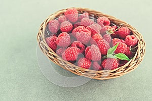 Fresh summer raspberry in a basket. Selective focus.