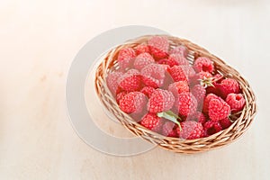 Fresh summer raspberry in a basket. Selective focus.