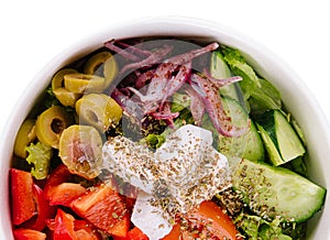 Fresh summer vegetable salad with lettuce, tomato, cucumber, bell pepper, onion and feta cheese