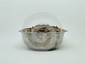 fresh sunflower seeds  white background, sunflower seeds in metal bowl