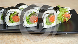 Fresh sushi rolls with salmon, lettuce