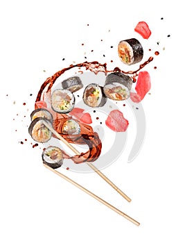 Fresh sushi rolls with splashes of soy sauce isolated on white background