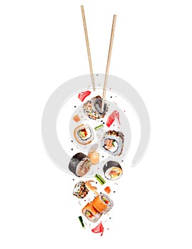 Fresh sushi rolls with various ingredients in the air isolated on a white background