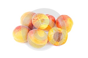 Fresh sweet apricot fruit, whole and half, group of juicy ripe apricots closeup, isolated on the white background