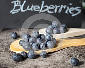 Fresh sweet blueberries on a wooden spoon