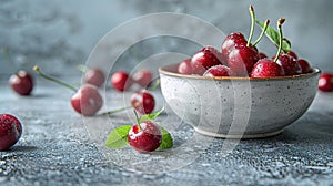 Fresh sweet cherries bowl with leaves in water drops on blue stone background, top view