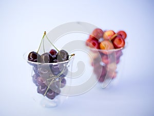 Fresh sweet cherries in a glass