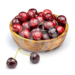 Fresh sweet cherries in wooden bowl isolated on white background.