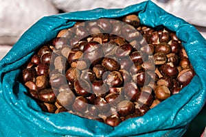 Fresh sweet chestnuts in the big sack at the Christmas market