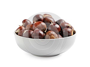 Fresh sweet edible chestnuts in bowl on white background