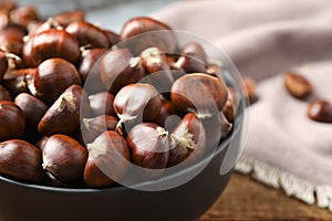 Fresh sweet edible chestnuts on table, closeup