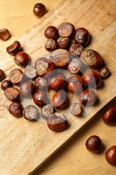 Fresh sweet edible chestnuts on wooden table