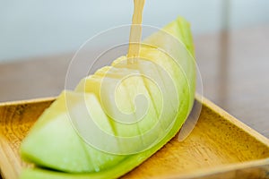 Fresh sweet green melon on wooden dish