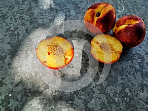 Fresh sweet group of peaches on dark background in the garden