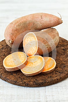 Fresh sweet potatoes and slices