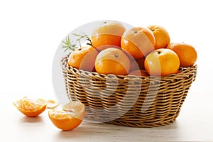 Fresh tangerine orange fruits in wooden basket