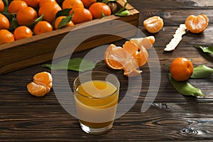 Fresh tangerine oranges on a wooden table. Peeled mandarin. Halves, slices and whole clementines closeup.