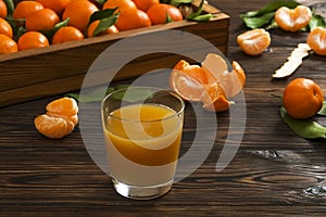 Fresh tangerine oranges on a wooden table. Peeled mandarin. Halves, slices and whole clementines closeup.