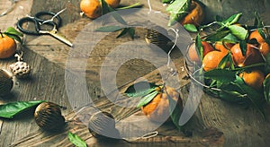 Fresh tangerines, decoration toys over wooden background, copy space