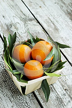 Fresh tangerines mandarins in a wicker basket