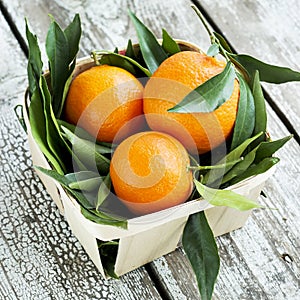 Fresh tangerines mandarins in a wicker basket