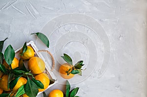 Fresh tangerines in white wooden tray