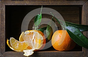 Fresh tangerines in a wooden box