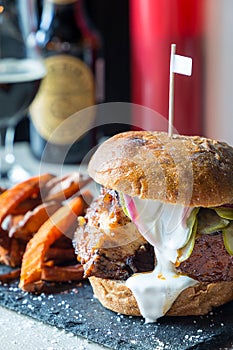 Fresh Tasty Bacon Big Burger with Fried Sweet Potatoes and White Sauce and Soft Drinks