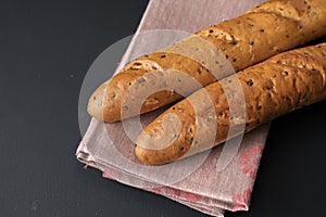 fresh tasty bread or baguette on black surface at the kitchens