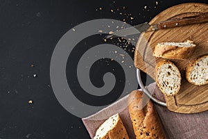 fresh tasty bread or baguette on black surface at the kitchens