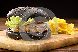 Fresh tasty burger and french fries on wooden table