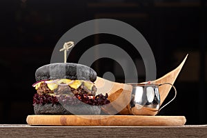 Fresh tasty burger and french fries on wooden table