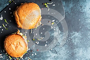 Fresh tasty burgers with roasted chicken, potato, micro greens and different herbs on the rustic background