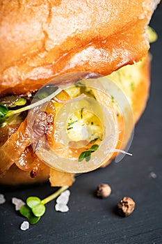 Fresh tasty burgers with roasted chicken, potato, micro greens and different herbs on the rustic background