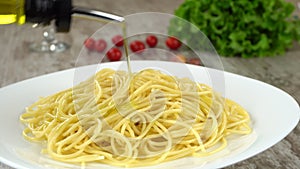 Fresh tasty olive oil pouring on a plate with homemade pasta. Prores, 4K.