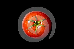Fresh tomato on a black background, top view. Organic food
