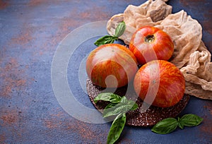 Fresh tomato on blue rusty background.