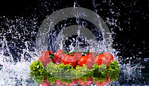 Fresh tomato cherry and green fresh salad with water drop splash on dark background Macro drops