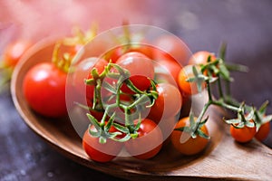 Fresh tomato cherry organic / Close up ripe red tomatoes wooden spoon background