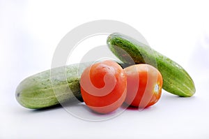 Fresh Tomato and cucumber isolated on white