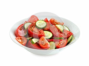 fresh tomato and cucumber salad salad in a white bowl, isolated on white