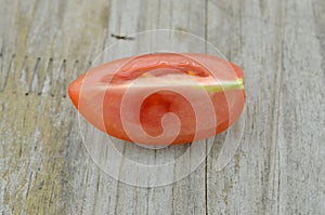 Fresh Tomato cut half on wooden background, decorate