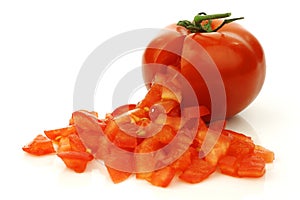 Fresh tomato with cut pieces coming out