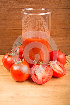 Fresh tomato drink on wooden table top view
