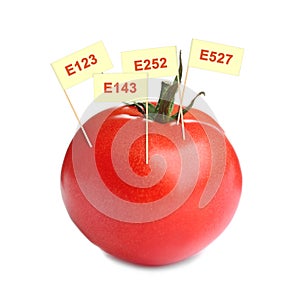 Fresh tomato with E numbers isolated. Harmful food additives